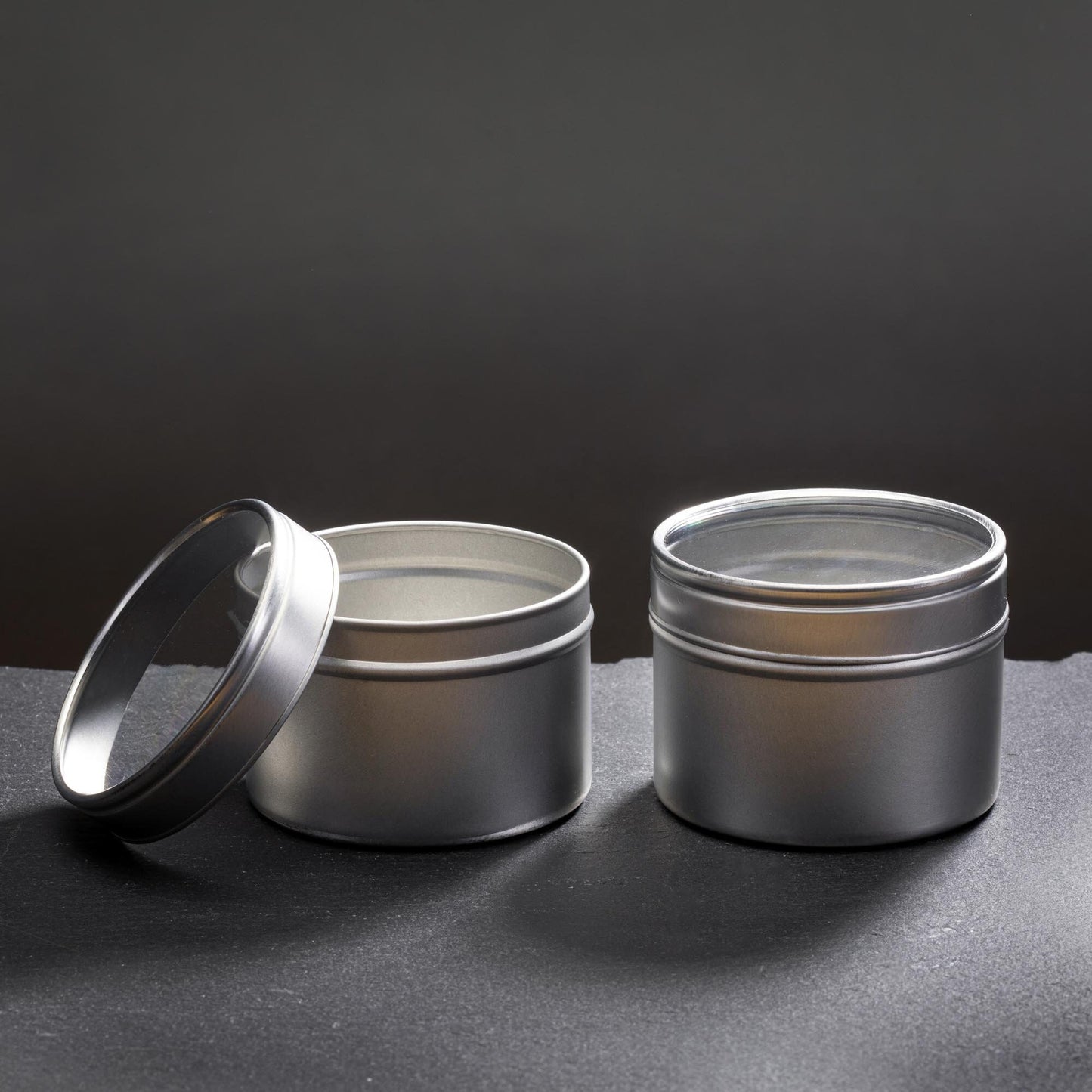 two tin candle containers