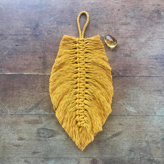 mustard yellow macrame feather with a citrine tumbled stone